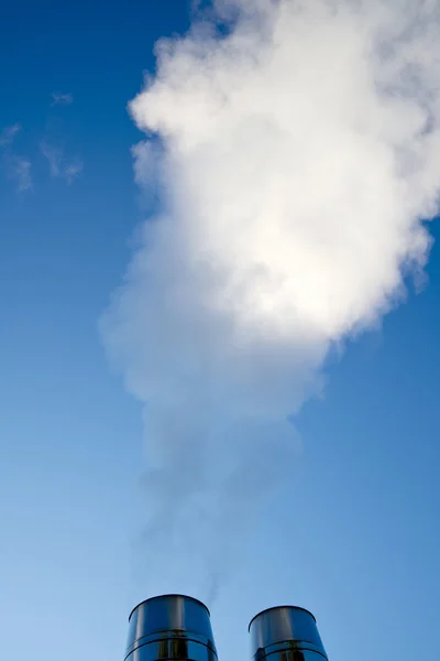 Industrial smoke from chimney on blue sky — Stock Photo, Image