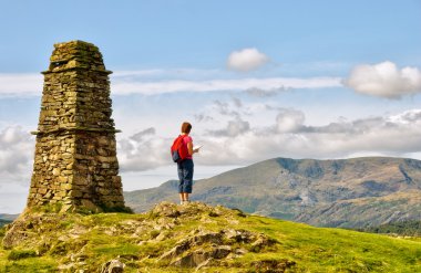 Female hiker on mountain summit clipart