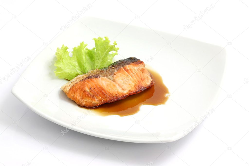 Grilled salmon with teriyaki sauce isolated in white background