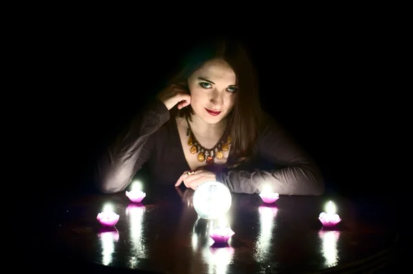 Fortune-teller with chrystal ball and candles Royalty Free Stock Images