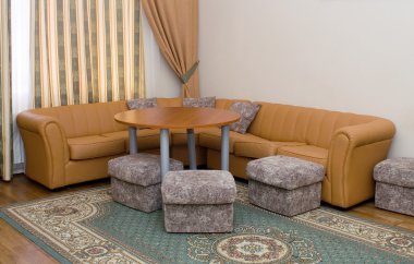 Sofa and round table in the suite clipart