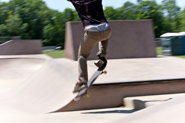 Skater Jumping at the Concrete Skate Park clipart