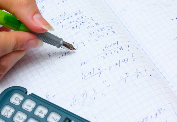 Home work, calculation with pen and calculator — Stock Photo, Image