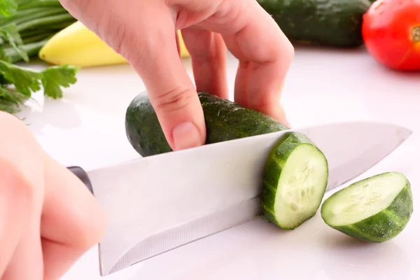 Someone cutting a cucumber — Stock Photo, Image