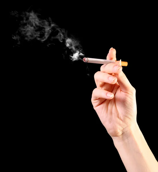 Mano de mujer sosteniendo un cigarrillo con humo — Foto de Stock