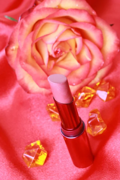 Lipstick on red background — Stock Photo, Image
