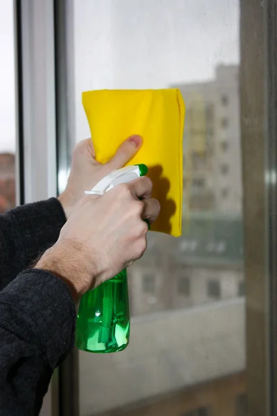 Hands spray clean the window