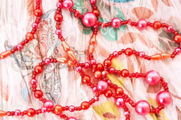 Red chaplet on textile background — Stock Photo, Image