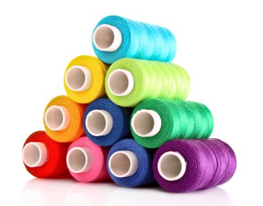 Pyramid of many-coloured bobbins of thread isolated on white clipart