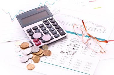 Calculator and some financial charts (Ukraininan coins) clipart