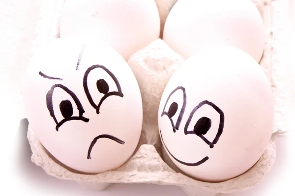 Olika ägg - med leende och arg — Stockfoto