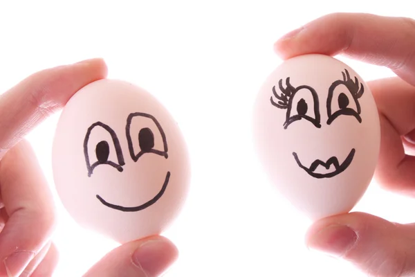 Twee eieren in handen geïsoleerd op wit — Stockfoto
