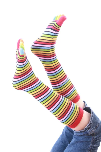 Kvinna ben i strip strumpa på vit bakgrund — Stockfoto