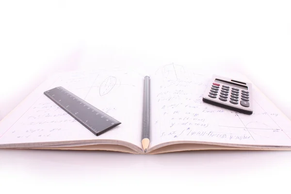 Calculator on notepad with calculations — Stock Photo, Image