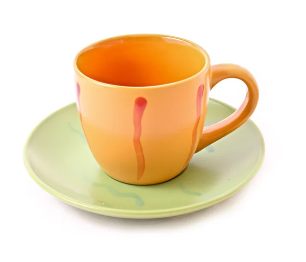 Xícara de laranja com pires isolados em branco — Fotografia de Stock