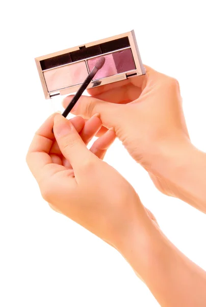 Set of four colors for makeup in the hands on white — Stock Photo, Image
