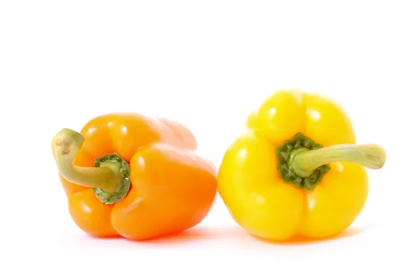 stock image Orange and yellow peppers isolated on white