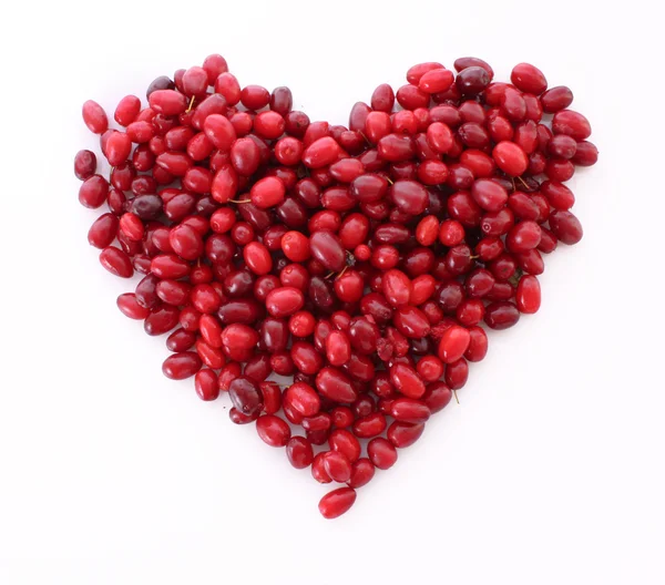 Cranberries in heart shape over white background — Stock Photo, Image