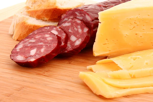 stock image Sausage and bread on wooden surface