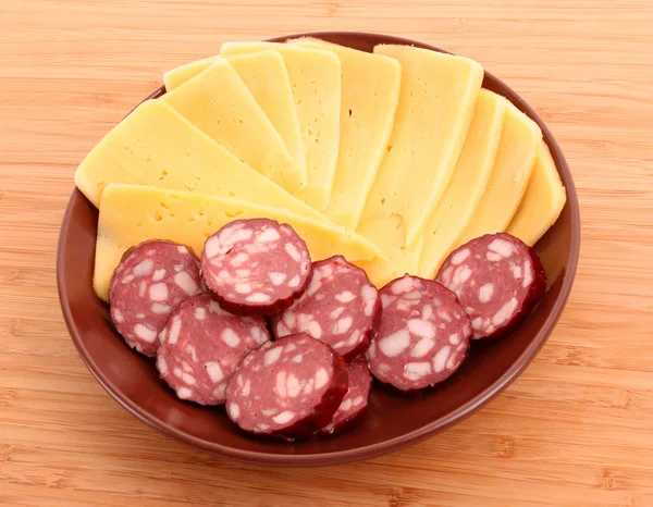 Sausage and cheese on plate isolated on white — Stock Photo, Image