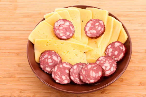 stock image Sausage and cheese in smile form on plate