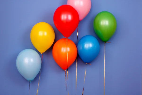 Flying balloons on blue background — Stock Photo, Image