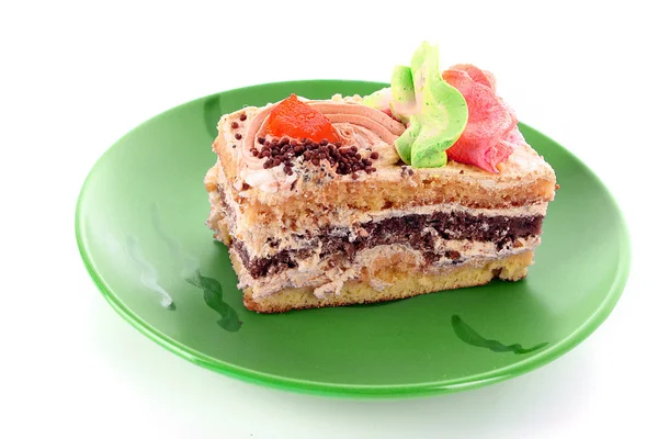 Dolce torta a forma di cuore su piatto verde — Foto Stock