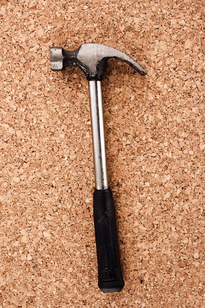 Hammer and pliers on cork board surface — Stock Photo, Image