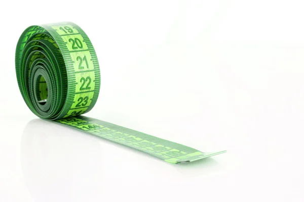 Twisted green measuring tape isolated on white — Stock Photo, Image
