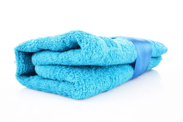 Folded blue towel with the band isolated on white — Stok fotoğraf