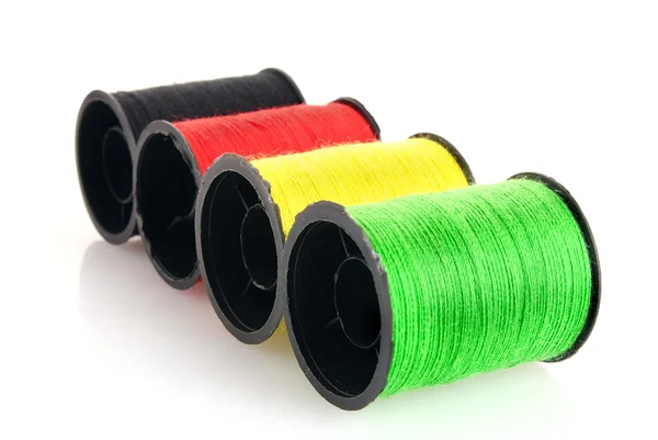 stock image Coloured bobbins of thread isolated on white