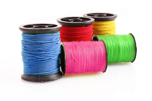 Gekleurde spoelkokers van wol geïsoleerd op wit — Stockfoto