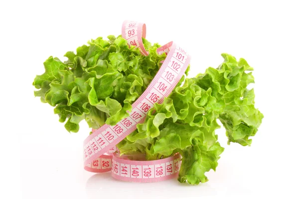 Green salad and measure tape isolated on white — Stock Photo, Image