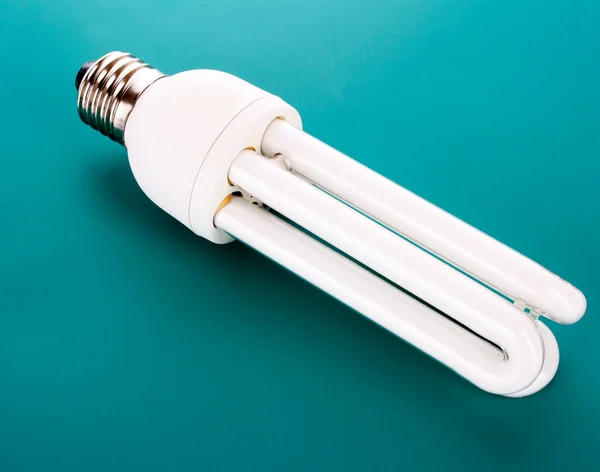 Energy saving light bulb on blue — Stockfoto
