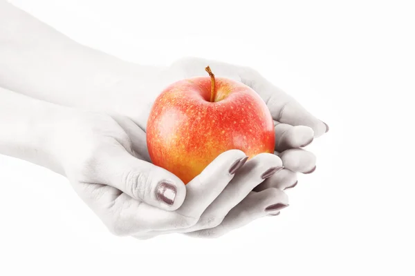 苹果在上白色孤立的手上。黑与白的手 — 图库照片
