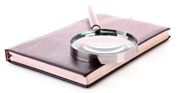 stock image Notebook with a magnifier on it isolated on white