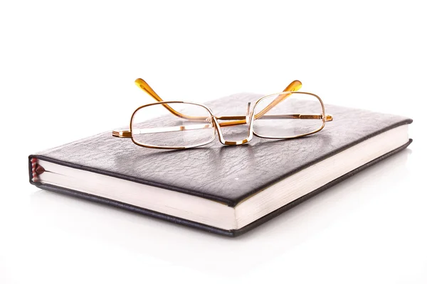 Notebook with glasses isolated on white — Stock Photo, Image