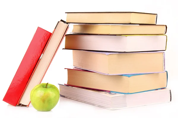 Hard cover books and green apple isolated on white — Stock Photo, Image