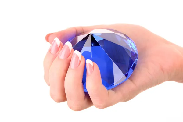 Гігантський блакитний діамант в руці ізольований на білому — стокове фото