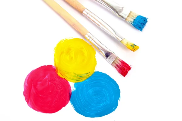 Üç temel renk boya ve fırça üzerinde beyaz izole — Stok fotoğraf
