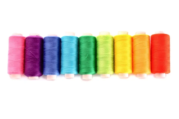 Montón de bobinas coloreadas de hilo lurex aisladas en blanco —  Fotos de Stock