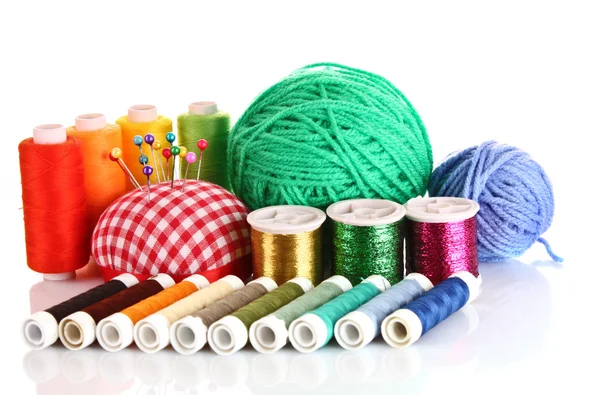 Coloured bobbins of threads, woolen balls and cushion for pins — Stock Photo, Image