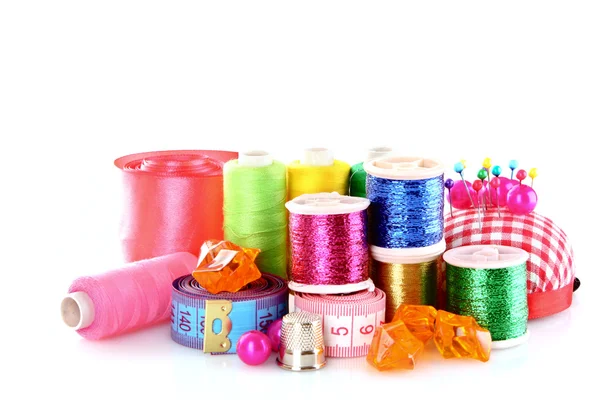 Coloured bobbins of threads, woolen balls and cushion for pins i — Stock Photo, Image
