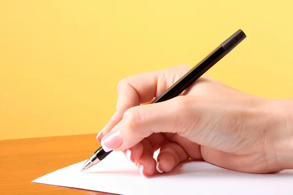 Writing on blank paper, yellow background — Stock Photo, Image