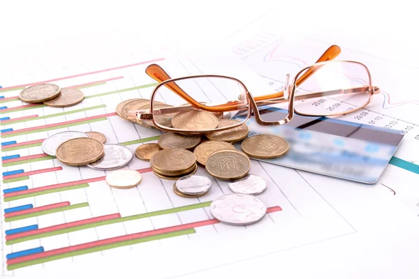 Glasses, credit card, coins and charts (Ukraininan coins) — Stock Photo, Image