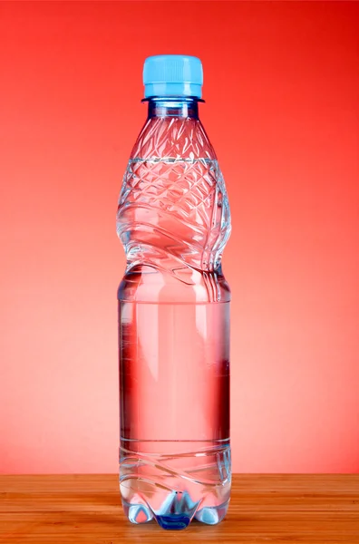 Bottles of water on red background — Stock Photo, Image
