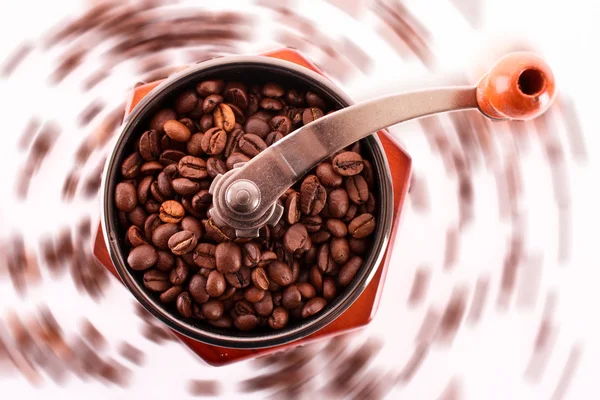 Coffee Grinder closeup and coffee beans rotation on white backgr — Stock Photo, Image
