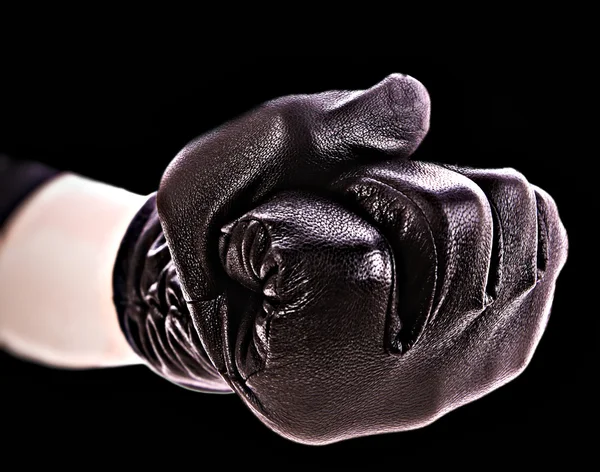 Näve i handskar på svart bakgrund — Stockfoto