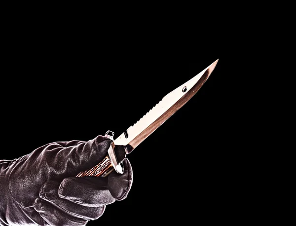 stock image Knife in black glove isolated on black