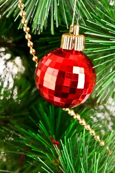 Red Christmas balls among green new year tree — Stock Photo, Image